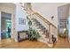 Foyer showcases a staircase with white railings, hardwood floors, and wainscoting at 340 Andrews Store Rd, Pittsboro, NC 27312