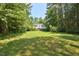 Spacious front yard with mature trees framing a lovely two-story home at 340 Andrews Store Rd, Pittsboro, NC 27312