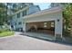 View of the open, attached garage with a concrete floor and storage space, providing ample room for vehicles and projects at 340 Andrews Store Rd, Pittsboro, NC 27312