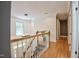 Upstairs hallway featuring wood floors and white railing at 340 Andrews Store Rd, Pittsboro, NC 27312