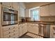 Well-lit kitchen features stainless steel appliances, white cabinetry and granite countertops at 340 Andrews Store Rd, Pittsboro, NC 27312