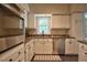 Window above the sink to the left of the stainless steel dishwasher and oven at 340 Andrews Store Rd, Pittsboro, NC 27312