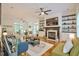 Bright living room featuring hardwood floors, fireplace, built-in bookshelves, and access to the outdoor space at 340 Andrews Store Rd, Pittsboro, NC 27312