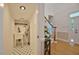 Hallway featuring a laundry sink, shelving, and entryway access with a wood-finished staircase at 340 Andrews Store Rd, Pittsboro, NC 27312