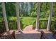 Covered patio featuring brick flooring and elegant columns, overlooks a lush green yard and provides outdoor seating space at 340 Andrews Store Rd, Pittsboro, NC 27312