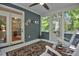 Inviting screened porch with rocking chairs, ceiling fan, and access to the outdoor living space at 340 Andrews Store Rd, Pittsboro, NC 27312