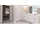 Bright bathroom with double vanity, a large mirror, and tiled floors at 534 Glenkirk Pl # 110, Garner, NC 27529