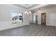 Bright dining area featuring chair rail molding, chandelier, and large window at 534 Glenkirk Pl # 110, Garner, NC 27529