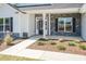 Inviting front porch with stone accents, manicured landscaping, and a well-lit entrance at 534 Glenkirk Pl # 110, Garner, NC 27529