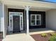 Inviting front porch with stone accents, a decorative wreath, and a well-lit entrance at 534 Glenkirk Pl # 110, Garner, NC 27529