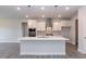 Contemporary kitchen with white cabinetry, island, stainless steel appliances, and sleek lighting at 534 Glenkirk Pl # 110, Garner, NC 27529