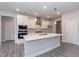 Modern kitchen boasts white cabinets, stainless steel appliances, and a large island at 534 Glenkirk Pl # 110, Garner, NC 27529