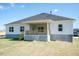 A view of the home's rear exterior with white siding, a covered porch and wood railings at 534 Glenkirk Pl # 110, Garner, NC 27529