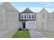 Charming two-story home features a gray exterior, attached garage and manicured lawn at 535 Eversden Dr, Zebulon, NC 27597