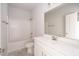 Clean bathroom featuring a tub and shower combination, a spacious vanity, and a large mirror at 563 Glenkirk Pl # 104, Garner, NC 27529