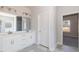 Bright bathroom with double vanity, tile flooring, and a large mirror at 563 Glenkirk Pl # 104, Garner, NC 27529