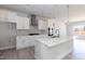 Bright kitchen with white cabinets, a large island, modern appliances, and light hardwood flooring at 563 Glenkirk Pl # 104, Garner, NC 27529