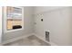 This laundry room has tile floors, a window for natural light, and a shelf for storage at 563 Glenkirk Pl # 104, Garner, NC 27529