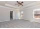 Spacious main bedroom with a tray ceiling, neutral carpet, and plenty of natural light at 563 Glenkirk Pl # 104, Garner, NC 27529