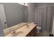 Bathroom featuring a double sink vanity with a large mirror, a toilet, and a shower with a patterned curtain at 101 Clardona Way, Holly Springs, NC 27540