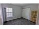 Bedroom with plush carpeting, a window with blinds, and a spacious closet for ample storage space at 101 Clardona Way, Holly Springs, NC 27540