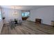 Open concept dining area with modern chandelier and hardwood floors at 101 Clardona Way, Holly Springs, NC 27540