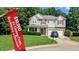 Charming two-story home with a well-manicured lawn, a two-car garage, and mature landscaping at 101 Clardona Way, Holly Springs, NC 27540