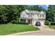 Charming two-story home with stone accents, neutral siding, red shutters, and a two-car garage at 101 Clardona Way, Holly Springs, NC 27540