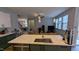 Modern kitchen with gray island, white cabinets, and pendant lighting at 101 Clardona Way, Holly Springs, NC 27540