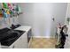 Functional laundry room with modern washer and dryer units, storage shelving, and a utility sink at 101 Clardona Way, Holly Springs, NC 27540