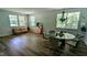 Bright living room with hardwood floors, large windows, and modern decor at 101 Clardona Way, Holly Springs, NC 27540