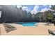 A tranquil neighborhood pool offers a refreshing escape amidst lush greenery and sunny skies at 101 Clardona Way, Holly Springs, NC 27540