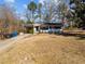 White brick ranch home with landscaping and driveway at 1805 Pritchard Pl, Durham, NC 27707