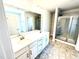 Bathroom featuring double vanity, large mirror, tiled floor, and a glass enclosed shower at 211 Drayton Hall Ln, Sanford, NC 27330