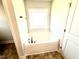 Bright bathroom showcasing a soaking tub with chrome fixtures and a window for natural light at 211 Drayton Hall Ln, Sanford, NC 27330