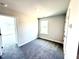 Bright bedroom featuring neutral carpet, a window, and fresh paint at 211 Drayton Hall Ln, Sanford, NC 27330