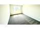 Carpeted bedroom featuring neutral colored walls and a window providing natural light at 211 Drayton Hall Ln, Sanford, NC 27330