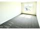 Bedroom with carpet, neutral paint, and a window overlooking the neighborhood at 211 Drayton Hall Ln, Sanford, NC 27330
