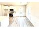 Elegant dining area showcasing modern flooring, chair rail, and abundant natural light at 211 Drayton Hall Ln, Sanford, NC 27330