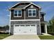 Charming two-story home featuring stone accents, a two-car garage, and classic architectural design at 211 Drayton Hall Ln, Sanford, NC 27330