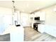 Stylish kitchen featuring white cabinets, stainless steel appliances, and modern lighting at 211 Drayton Hall Ln, Sanford, NC 27330