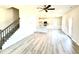 Spacious open-concept living area showcasing modern flooring, a staircase, and a stylish kitchen at 211 Drayton Hall Ln, Sanford, NC 27330
