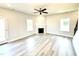 Bright living room featuring modern floors, a cozy fireplace, and abundant natural light at 211 Drayton Hall Ln, Sanford, NC 27330