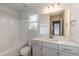 Bathroom featuring white cabinets, a tub and shower combination, and a toilet at 69 Streamline Ct, Lillington, NC 27546