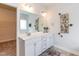 Bright bathroom featuring double sinks, white cabinets and a large mirror at 69 Streamline Ct, Lillington, NC 27546