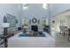 Bright, airy living room with tall ceilings, fireplace, and large windows overlooking the yard at 69 Streamline Ct, Lillington, NC 27546