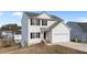 Two-story house with white siding, black shutters, and a two-car garage at 7041 Spanglers Spring Way, Raleigh, NC 27610