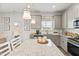 Stylish kitchen featuring granite countertops, gray cabinets, and modern lighting fixtures at 111 Vili Dr, Broadway, NC 27505