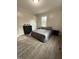 This staged bedroom features plank flooring, paint, and decor at 1118 Jackson St, Burlington, NC 27217