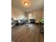 Cozy living room with hardwood floors, two sofas, window with natural light, and overhead lighting at 1118 Jackson St, Burlington, NC 27217